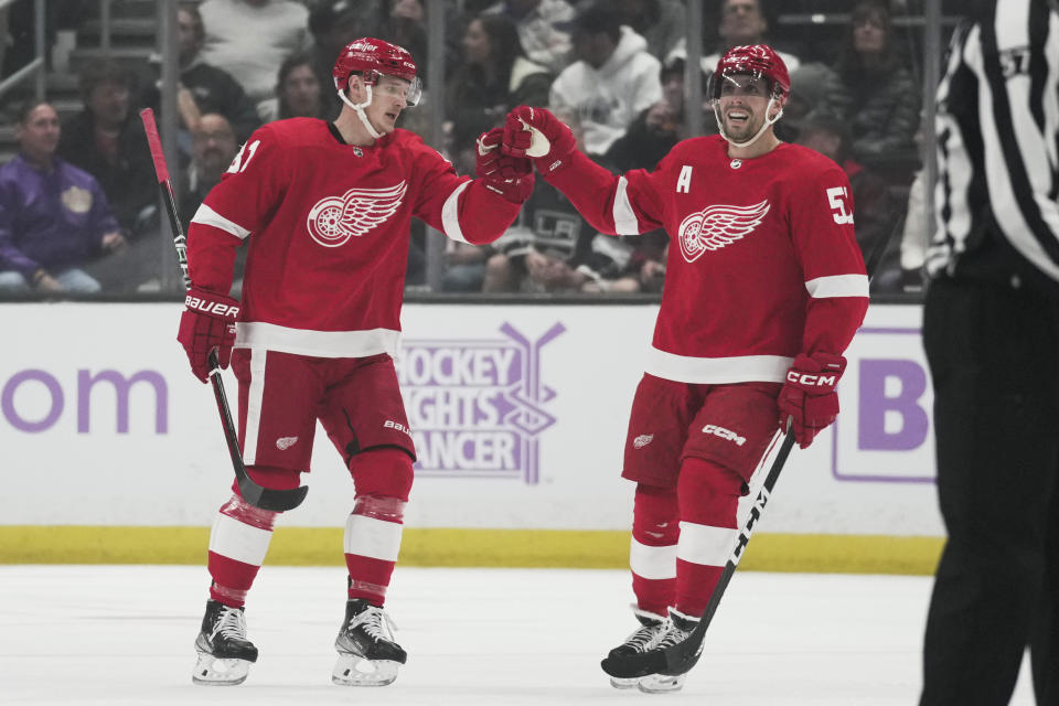Detroit Red Wings left wing Dominik Kubalik (81) celebrates with left wing David Perron (57) after scoring during the first period of an NHL hockey game against the Los Angeles Kings Saturday, Nov. 12, 2022, in Los Angeles. (AP Photo/Ashley Landis)