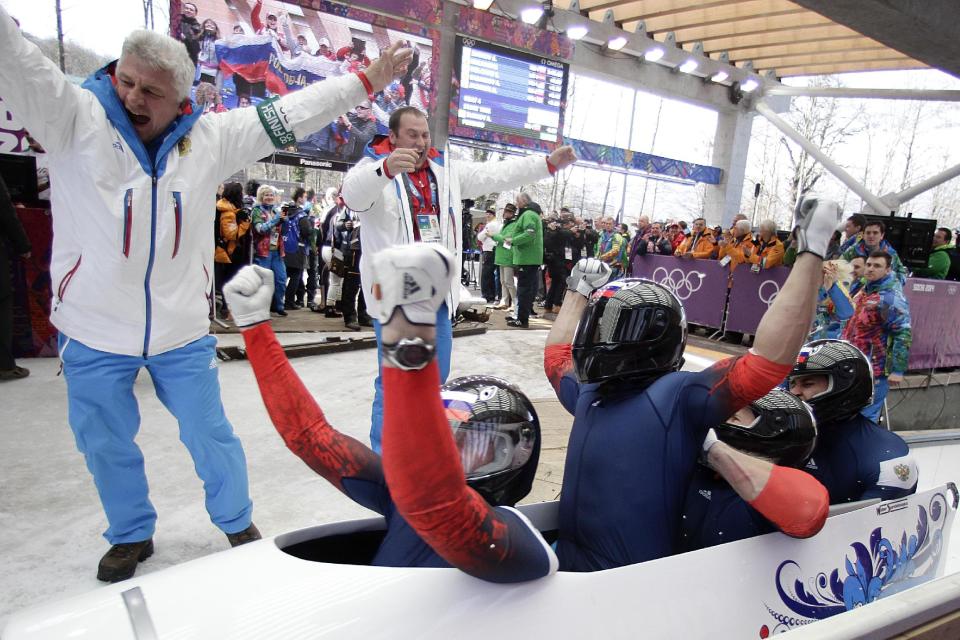 The team from Russia RUS-1, with Alexander Zubkov, Alexey Negodaylo, Dmitry Trunenkov, and Alexey Voevoda, celebrate after they won the gold medal during the men's four-man bobsled competition final at the 2014 Winter Olympics, Sunday, Feb. 23, 2014, in Krasnaya Polyana, Russia. (AP Photo/Jae C. Hong)