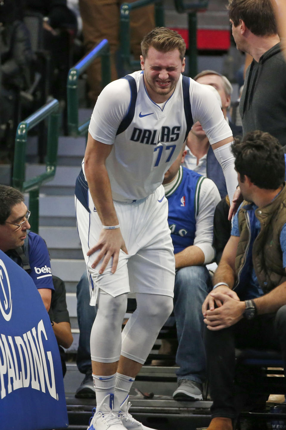 Dallas Mavericks forward Luka Doncic (77) reacts after injuring himself against the Miami Heat during the first half of an NBA basketball game in Dallas, Saturday, Dec 14, 2019. (AP Photo/Michael Ainsworth)