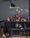 <p>Surprise the guys and ghouls in your household this October 31 with a spook-tacular Halloween celebration. Keep things far from kitschy with a DIY broom chandelier, which you can hang <a href="https://www.countryliving.com/diy-crafts/g1916/mason-jar-fall-crafts/" rel="nofollow noopener" target="_blank" data-ylk="slk:Mason jar;elm:context_link;itc:0;sec:content-canvas" class="link ">Mason jar</a> candles from using black twine. Shred a black linen tablecloth for extra eerie flair, then add candlesticks and votives for a haunting glow. </p>