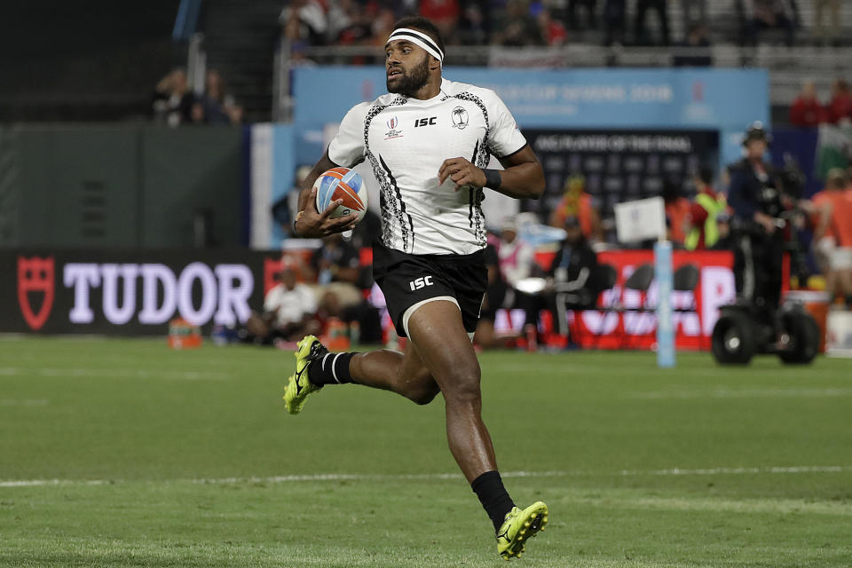 FILE - In this July 20, 2018, file photo, Fiji's Semi Kunatani scores against Japan during the Rugby Sevens World Cup in San Francisco. The Fiji Rugby Union criticized Monday, April 6, 2020, two of its top professional players, including Kunatani, who have been arrested for failing to self-isolate after returning to Fiji from overseas. Both players returned to Fiji via Singapore last weekend. They were arrested for failing to observe a 14-day quarantine designed the prevent the spread of Covid-19. Fiji has reported 12 cases. (AP Photo/Jeff Chiu, File)