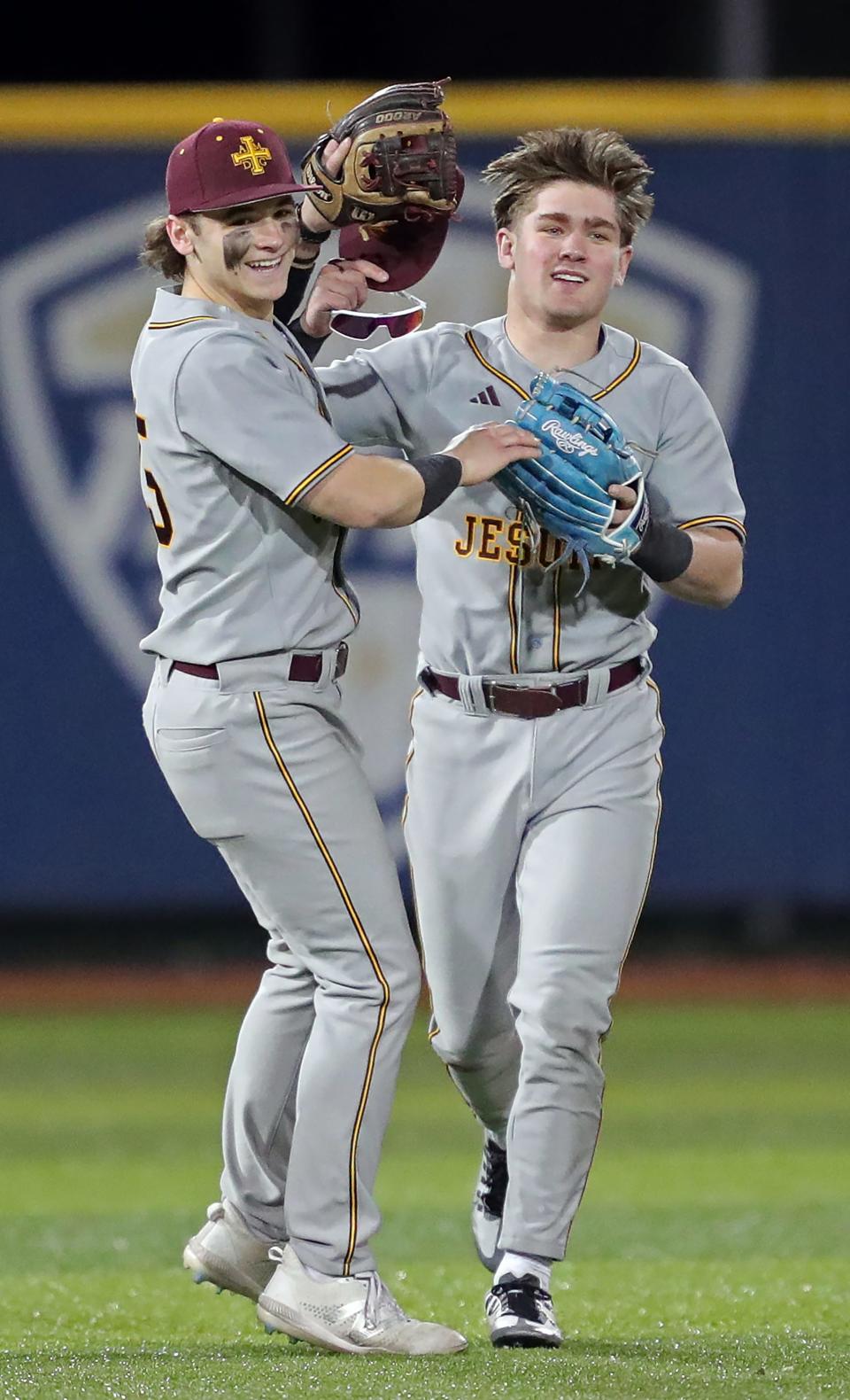 Walsh Jesuit shortstop Joey Canzoni, left, celebrates with left fielder Justin Bremner after he caught the final out of the fourth inning during a game at Kent State University's Schoonover Stadium on April 6.