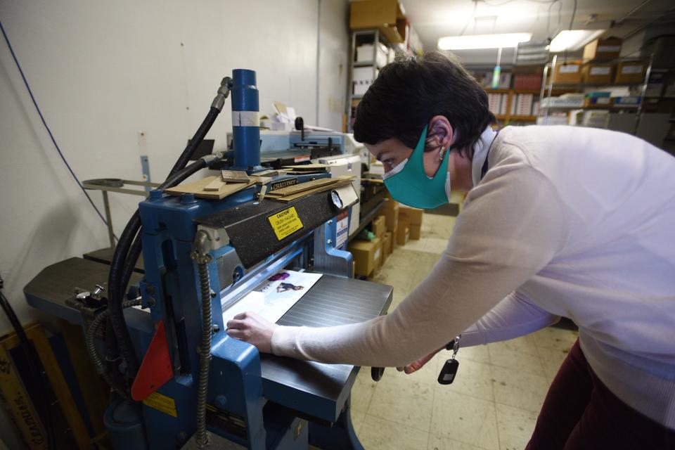 Erin Bracken, owner and operator of O'Shea Printing & Graphics in Hackensack, cuts a batch of papers at the store on Tuesday February 15,2022.