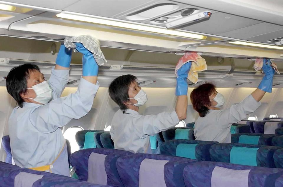 Three cleaners of Cathay Pacific Airways disinfect a plane in Hong Kong, south China, Thursday, May 15, 2003.