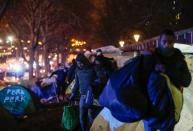 French police clear out migrants from an illegal camp in north Paris