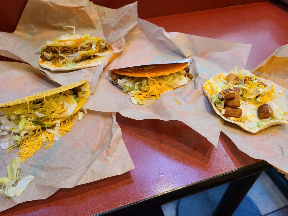 different tacos from taco bell lined up on a counter