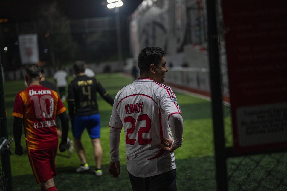Amateur players enter the pitch before playing a recreational soccer "Astroturf" match in Istanbul, Turkey, Tuesday, March 5, 2024. "Astroturf" matches in Turkey are usually 60 minutes and played 7 to 7 in half fields with no offside, no sliding tackles nor throw-ins. (AP Photo/Francisco Seco)