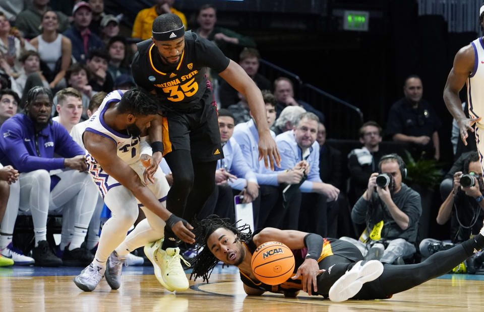 Arizona State guard Frankie Collins, right, tries to get control of the ball in front of guard Devan Cambridge, center, and TCU guard Mike Miles Jr. during the second half of a first-round college basketball game in the men's NCAA Tournament on Friday, March 17, 2023, in Denver. (AP Photo/John Leyba)