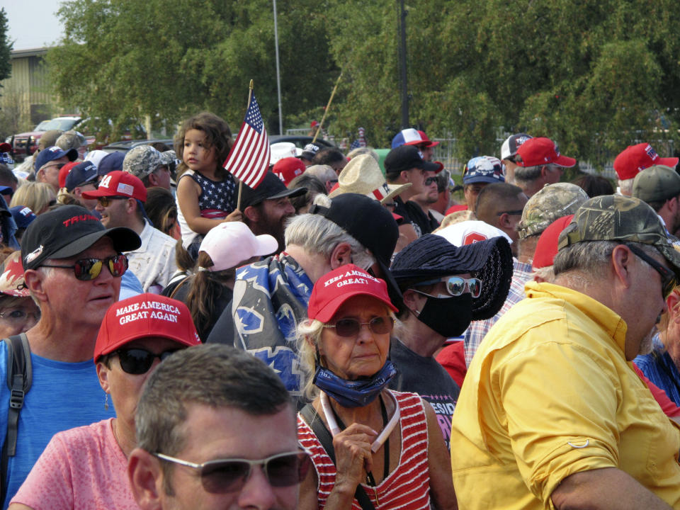 People line up outside the gates three hours before President Donald Trump is scheduled to speak Saturday night at a campaign rally at Minden-Tahoe Airport under smoky skies from California wildfires along the Sierra Nevada's eastern front in Minden, Nev., Saturday, Sept. 12, 2020 (AP Photo/Scott Sonner)