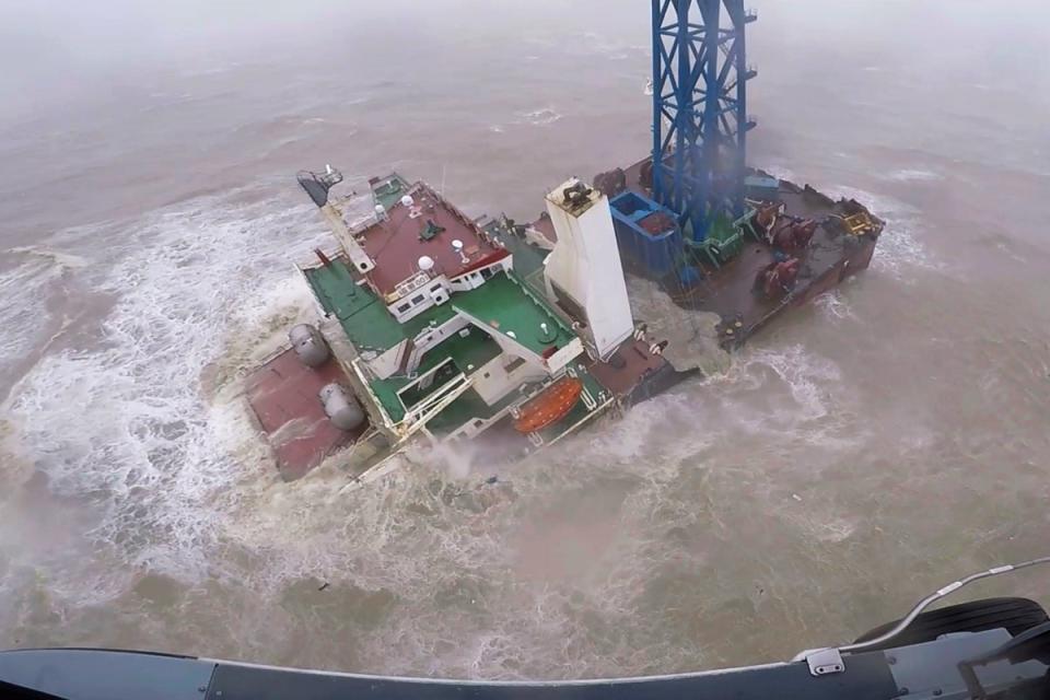 A rescue crew approaches a sinking ship near Hong Kong (AP)