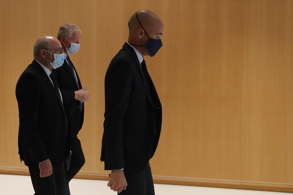 Chairman of the Representative Council of French Jewish Institutions (Crif) Francis Kalifat, left, arrives at the courtroom for the opening of the 2015 attacks trial, Wednesday, Sept. 2, 2020 in Paris. Thirteen men and a woman go on trial Wednesday over the 2015 attacks against a satirical newspaper and a kosher supermarket in Paris that marked the beginning of a wave of violence by the Islamic State group in Europe. Seventeen people and all three gunmen died during the three days of attacks in January 2015. (AP Photo/Francois Mori)