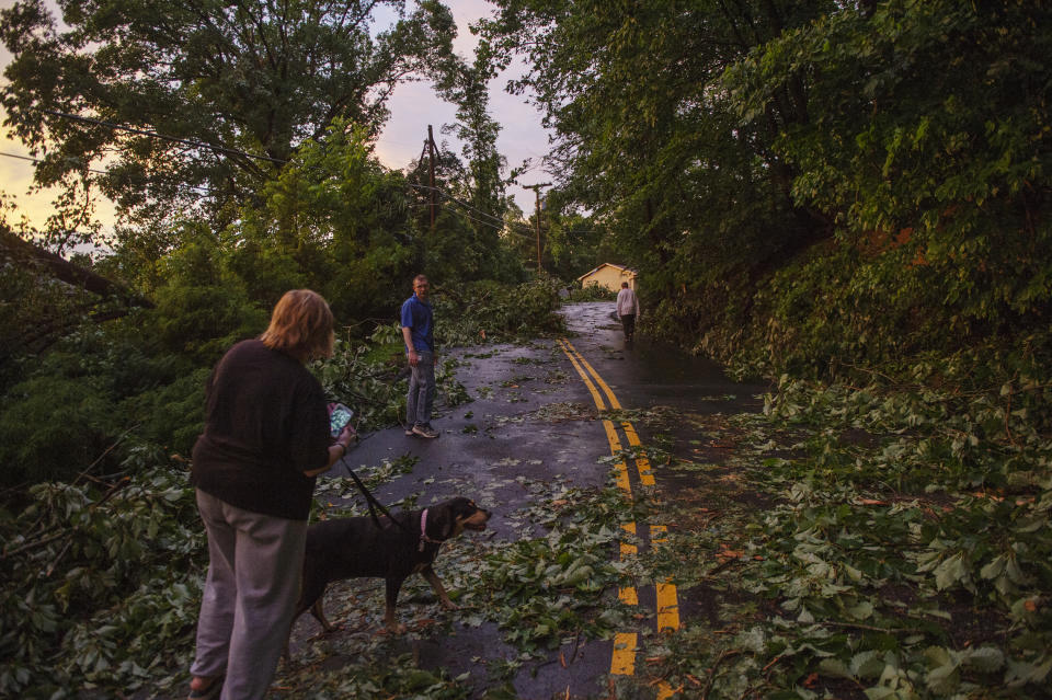 People walk along Hickory Road after a suspected tornado tore through Charleston, W.Va., on Monday, June 24, 2019. (Craig Hudson/Charleston Gazette-Mail via AP)