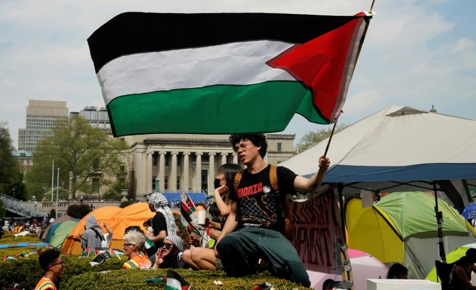 A protester waving a Palestinian flag during the Columbia protests. AFP via Getty Images