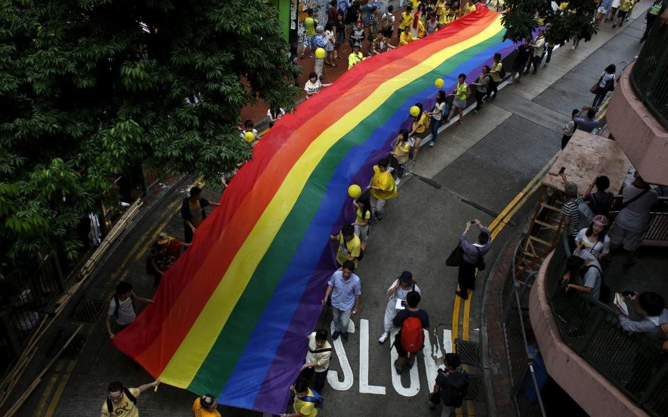 Participants march with a banner with rainbow colours during the annual pride parade in Hong Kong - REUTERS