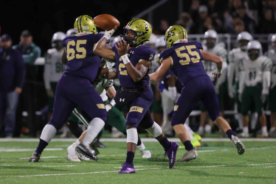 Delaware Military Academy quarterback Brian Alleyne (2) attempts a pass in the pocket against Archmere in 2021.