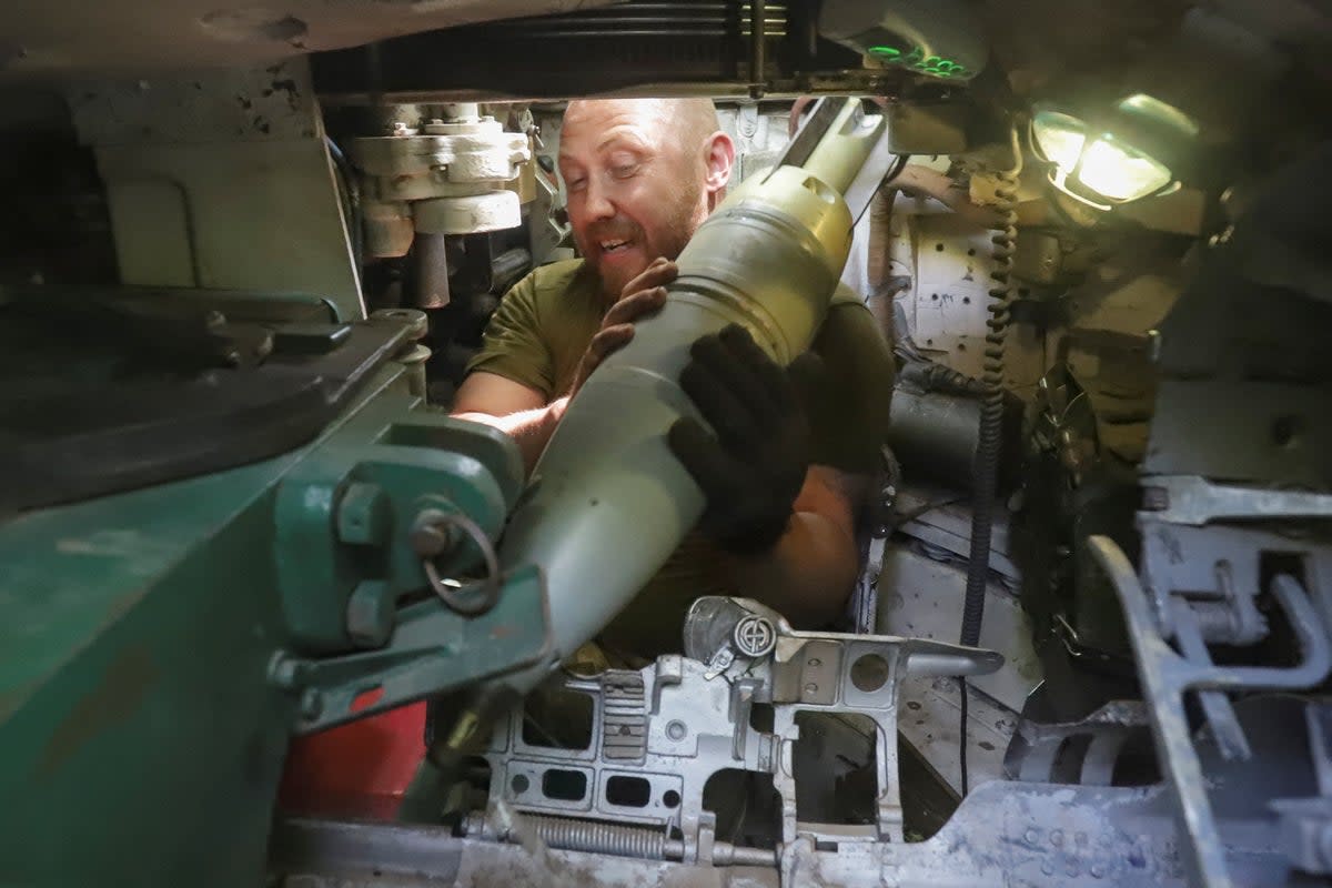 A Ukrainian serviceman loads a shell into a tank at a position in the Donetsk region (Reuters)