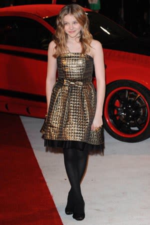 She paired a metallic gold rock with black opaque tights at the UK premiere of "Kick-Ass".