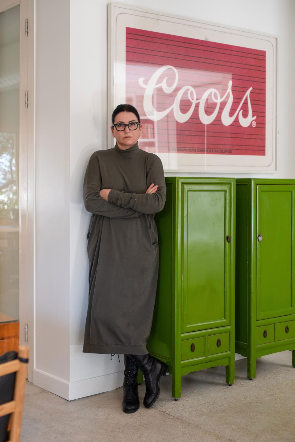 The entrance to the studio on the second floor of the house leads to a pair of lime green Chinese cabinets purchased at a local antique shop.