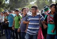 Security forces are seen as migrants march in a caravan near Frontera Hidalgo