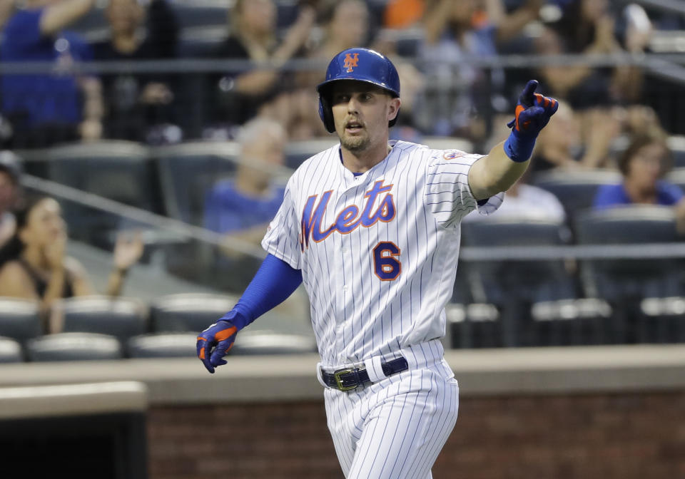 New York Mets' Jeff McNeil gestures to Robinson Cano after scoring on a single by Cano during the sixth inning of the team's baseball game against the Atlanta Braves on Saturday, June 29, 2019, in New York. (AP Photo/Frank Franklin II)