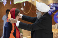 Britain's opposition Liberal Democrats party leader Jo Swinson, is welcomed during a visit to the Gurdwara Singh Sabha Temple during an election campaign stop in Glasgow, Scotland, Thursday Nov. 14, 2019. Britain's Brexit is one of the main issues for voters and political parties as the UK goes to the polls in a General Election on Dec. 12. (Jane Barlow/PA via AP)