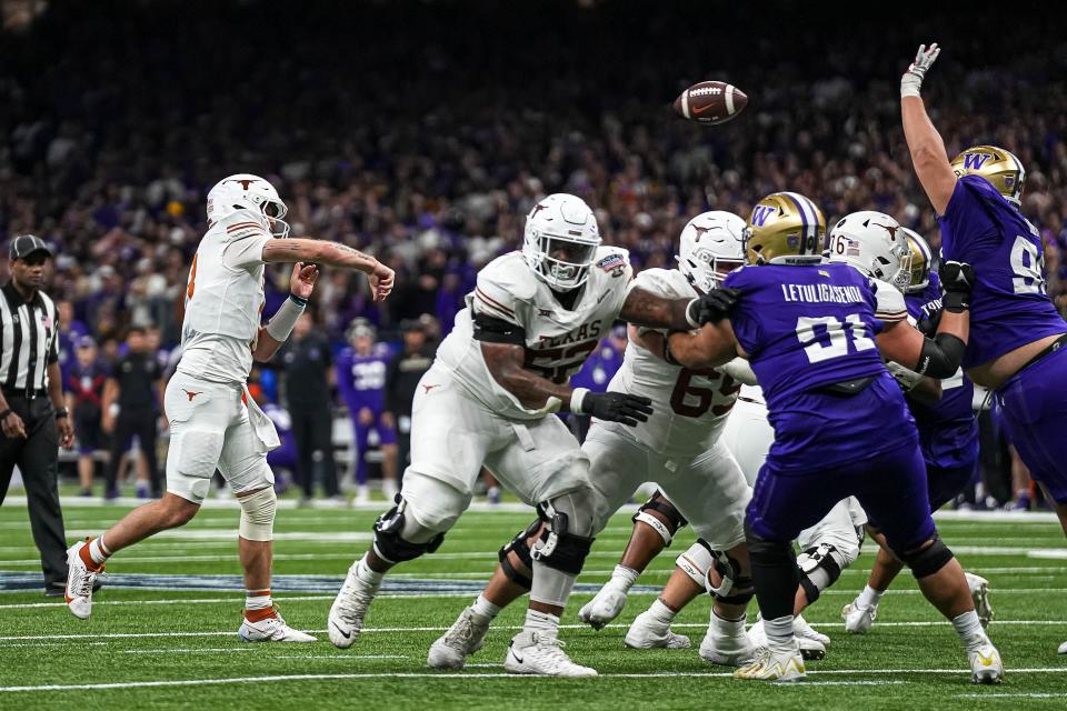 Texas quarterback Quinn Ewers throws a pass during Monday night's 37-31 loss to Washington in the Sugar Bowl. The Huskies sacked Ewers twice and took away his two most dangerous targets, Xavier Worthy and Adonai Mitchell, for most of the game.