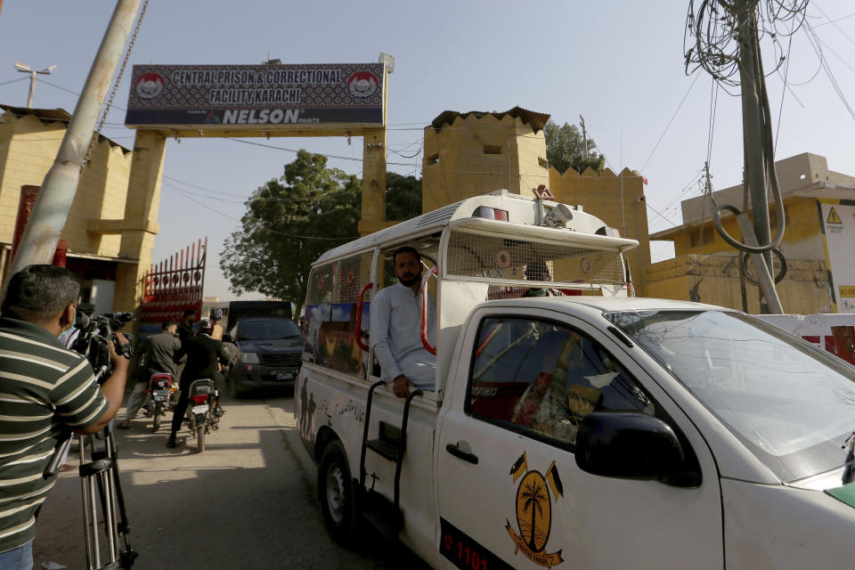 Police vehicles are driven out from the Karachi Central Prison where British-born Pakistani Ahmed Omar Saeed Sheikh, who was charged, convicted and later acquitted in the 2002 murder of American journalist Daniel Pearl is detained, in Karachi, Pakistan, Friday, Jan. 29, 2021. Pakistan is scrambling to manage the fallout of a Supreme Court decision to free the Pakistani-British man accused in the 2002 beheading of American Journalist Daniel Pearl. The Sindh Provincial government on Friday filed a review petition, asking the same court to revisit its decision. (AP Photo/Fareed Khan)