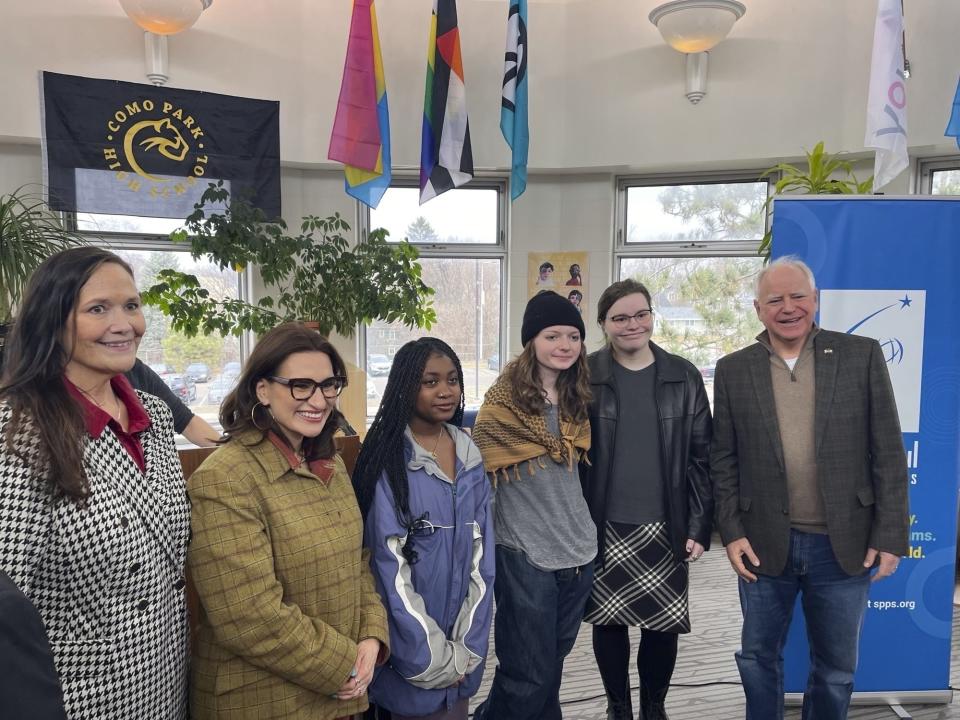 Bloomington Jefferson senior Shae Ross, fourth from left, joins Governor Tim Walz, right, and Lieutenant Governor Peggy Flanagan, second from left, at an event promoting proposed legislation to prevent books bans based on ideology at Como Park High School in St. Paul, Minnesota on March 21, 2024. (Chris Williams/Education Minnesota via AP)