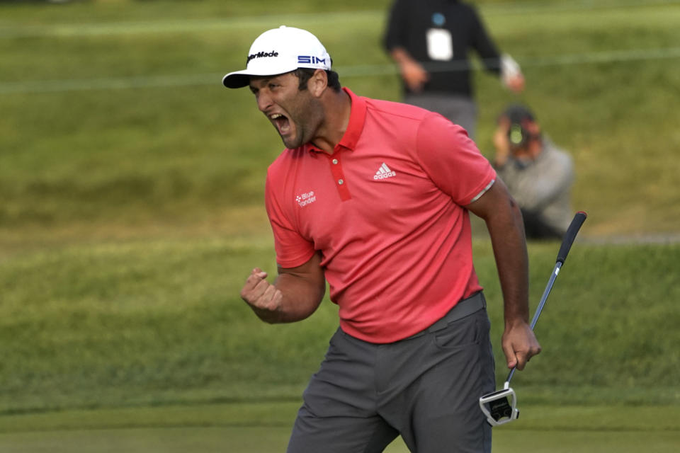 Jon Rahm reacts after making his putt on the first playoff hole during the final round of the BMW Championship golf tournament at the Olympia Fields Country Club in Olympia Fields, Ill., Sunday, Aug. 30, 2020. Rahm wasn't aware Dustin Johnson had forced the playoff because without a gallery there was no cheer. (AP Photo/Charles Rex Arbogast)