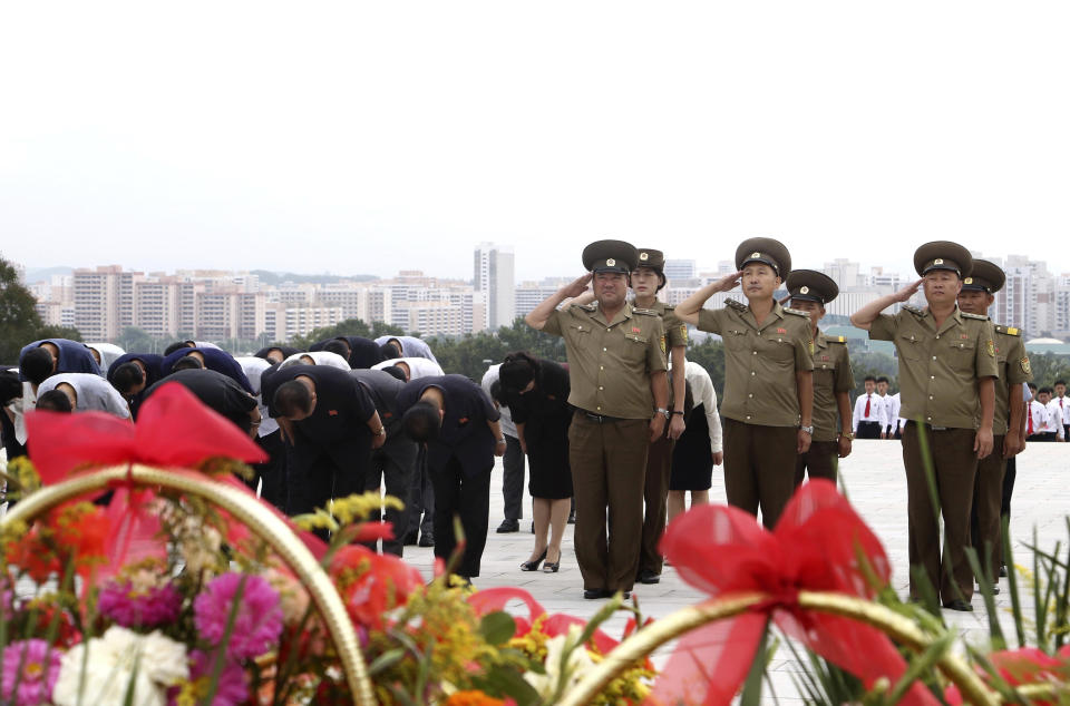 Pyongyang citizens pay tribute to the statues of their late leaders Kim Il Sung and Kim Jong Il on Mansu Hill on the occasion of the 62nd anniversary of Kim Jong Il's first field guidance for the revolutionary armed forces in Pyongyang, North Korea Thursday, Aug. 25, 2022. (AP Photo/Cha Song Ho)