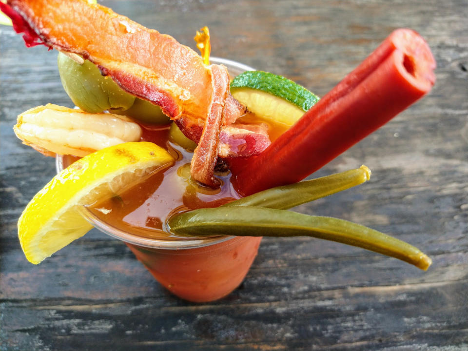 A Bloody Mary cocktail with meat toppings