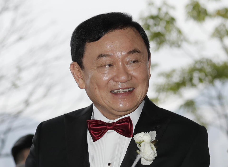 FILE - In this Friday, March 22, 2019 file photo, Former Thai Prime Minister Thaksin Shinawatra welcomes his guests for the wedding of his youngest daughter Paetongtarn Shinawatra at a hotel in Hong Kong. The youngest daughter of Thailand’s former prime minister Thaksin Shinawatra, whose ouster by a military coup in 2006 triggered years of political instability, has taken a post with a party closely associated with her father. Thailand’s largest opposition party, Pheu Thai, announced Thursday, Oct. 28, 2021 at its general assembly that Paetongtarn Shinawatra has been named one of its advisors. (AP Photo/Kin Cheung)