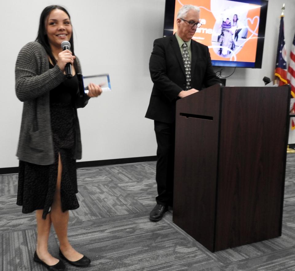 Malyia William of River View High School accepts the Local Hero Award from Superintendent Steve Oster at the recent Board of Developmental Disabilities annual luncheon. Williams staged a homecoming dance for those with developmental disabilities.