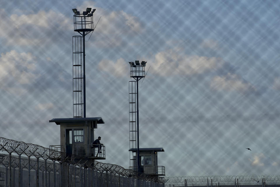 A prison guard sits in a watchtower at the Pinero jail in Pinero, Argentina, Tuesday, April 9, 2024. President Javier Milei has called for harsher penalties against drug traffickers and military intervention. (AP Photo/Natacha Pisarenko)