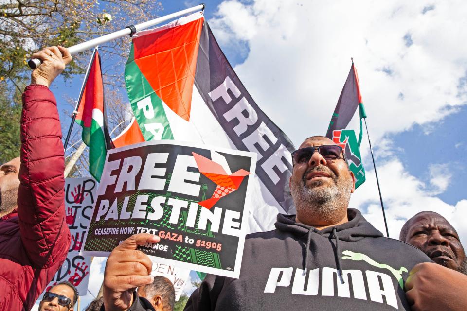 Participants carry Free Palestine flyers at a Rally in Support of Palestine that culminated with a march along Barley Mill Road to President Joe Biden's home in Greenville on Saturday, Nov. 11, 2023. According to event organizers, more than 1,500 people participated in the peaceful rally and march.