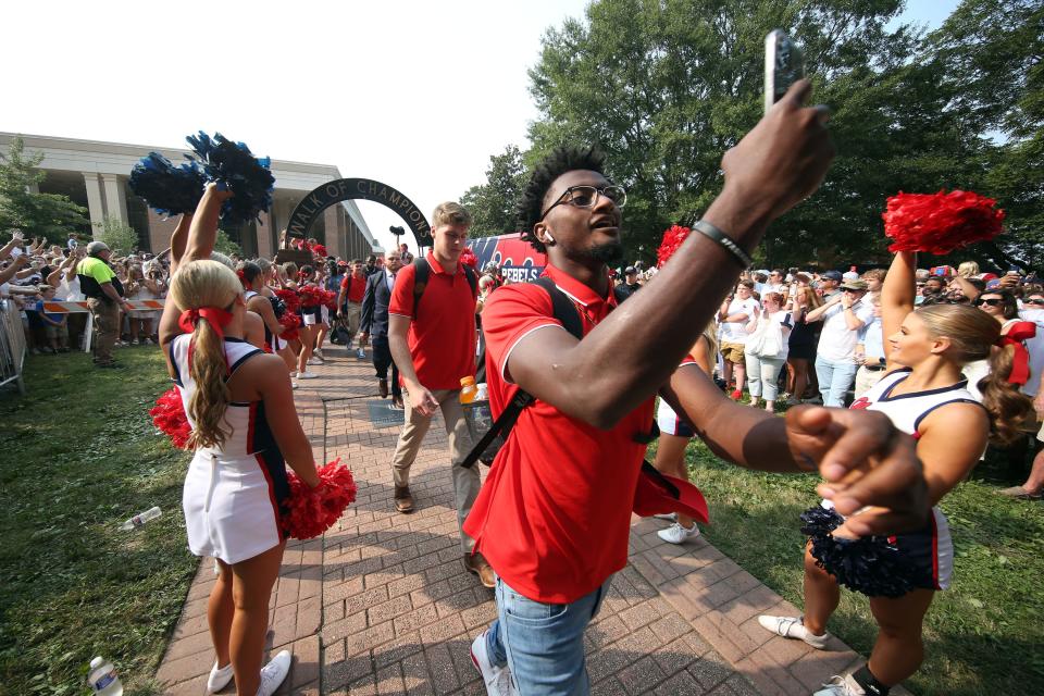 Sep 11, 2021; Oxford, Mississippi, USA; Mississippi Rebels defensive back Keidron Smith takes a selfie as he makes his way down the Walk of Champions before their game against the Austin Peay Governors at Vaught-Hemingway Stadium. Mandatory Credit: Petre Thomas-USA TODAY Sports