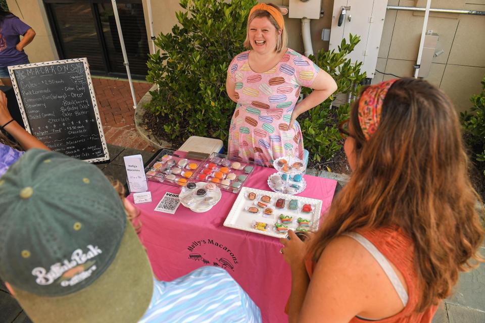 Melody Bennett of Melly's Macarons talks to visitors during the first Town Tailgate event at Carolina Wren Park in Anderson, S.C. Saturday, August 14, 2021. 