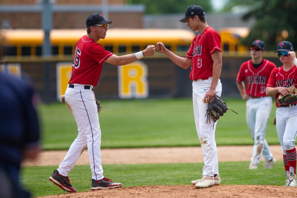 John Glenn's Colin Stephens, left, fist bumps Joe Chrapliwy during the regional semifinal baseball game Saturday, June 4, 2022 at Griffith High School. 