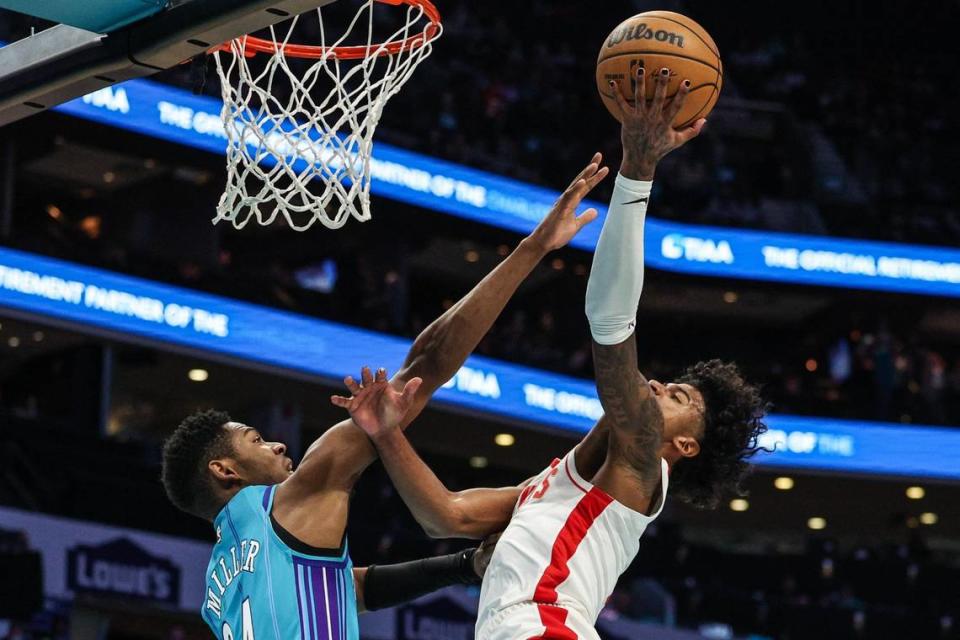 Hornets forward Brandon Miller, left, attempts to block a shot by Rockets guard Jalen Green during the game at Spectrum Center on Friday, January 26, 2024.