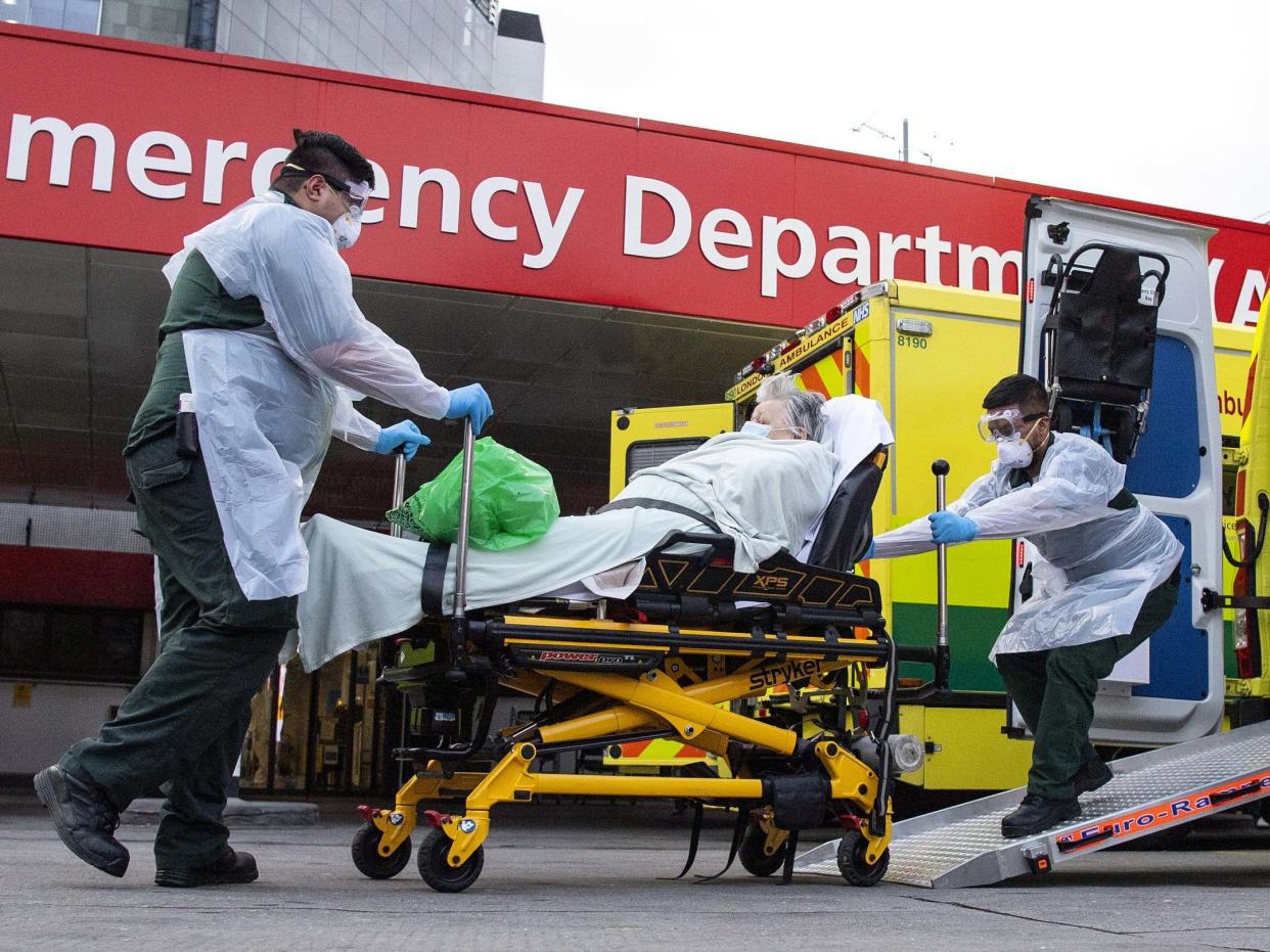 A woman is wheeled from an ambulance at St Thomas' Hospital in London, UK, 30 March 2020: Justin Setterfield/Getty Images