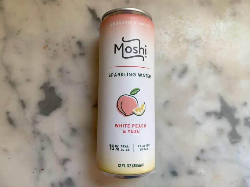 Can of Moshi White Peach & Yuzu Sparkling Water on marble counter