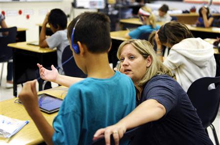 Fourth grade teacher Alicia Schoenborn works with a student at Mahnomen Elementary School in Mahnomen, Minnesota September 26, 2013. REUTERS/Dan Koeck