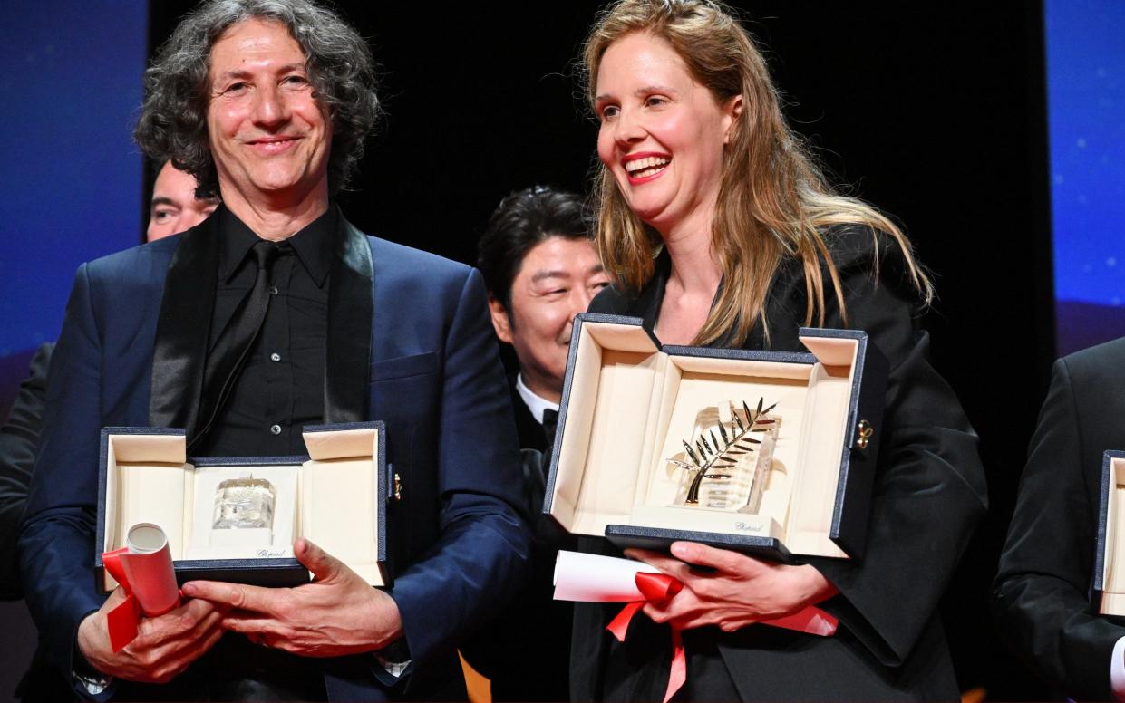 Jonathan Glazer and Justine Triet pose with their awards - Getty