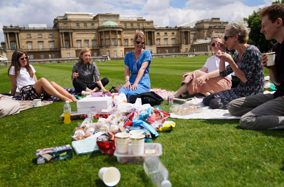 Visitors enjoy a picnic on the lawn during a preview of the Garden at Buckingham Palace, Queen Elizabeth II's official residence in London, which opens to members of the public on Friday. Visitors will be able to picnic in the garden and explore the open space for the first time. Picture date: Thursday July 8, 2021. (Photo by Kirsty O'Connor/PA Images via Getty Images)