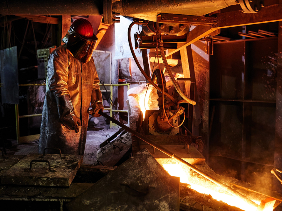  A worker in heat resistant protective clothing on the liquid copper mold production line at the KGHM Polska Miedz SA smelting plant in Glogow, Poland.