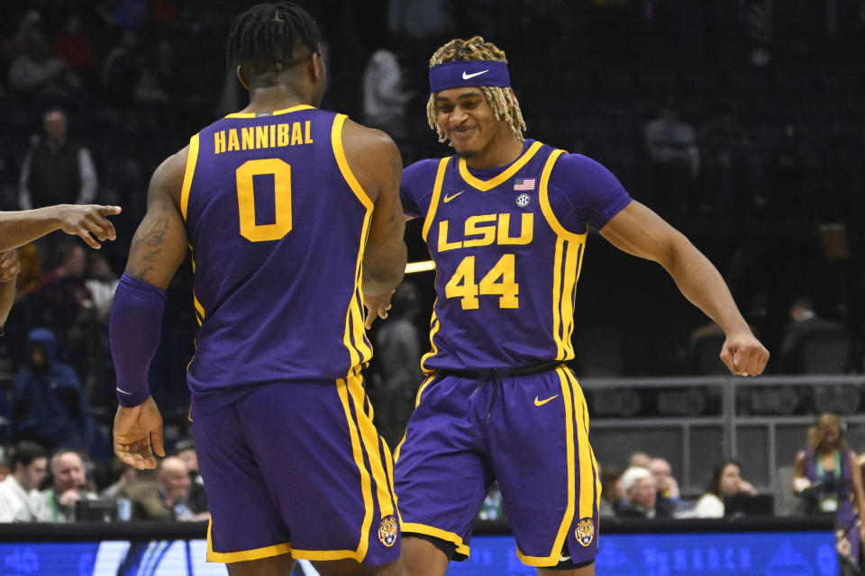 LSU guard Adam Miller (44) and Trae Hannibal celebrate after an NCAA college basketball game in the first round of the Southeastern Conference tournament, Wednesday, March 8, 2023, in Nashville, Tenn. LSU won 72-67. (AP Photo/John Amis)