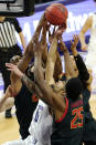 Northwestern guard Boo Buie, center, battles for a rebound against Maryland forward Donta Scott, left, forward Jairus Hamilton, right, and guard Aaron Wiggins during the second half of an NCAA college basketball game in Evanston, Ill., Wednesday, March 3, 2021. (AP Photo/Nam Y. Huh)