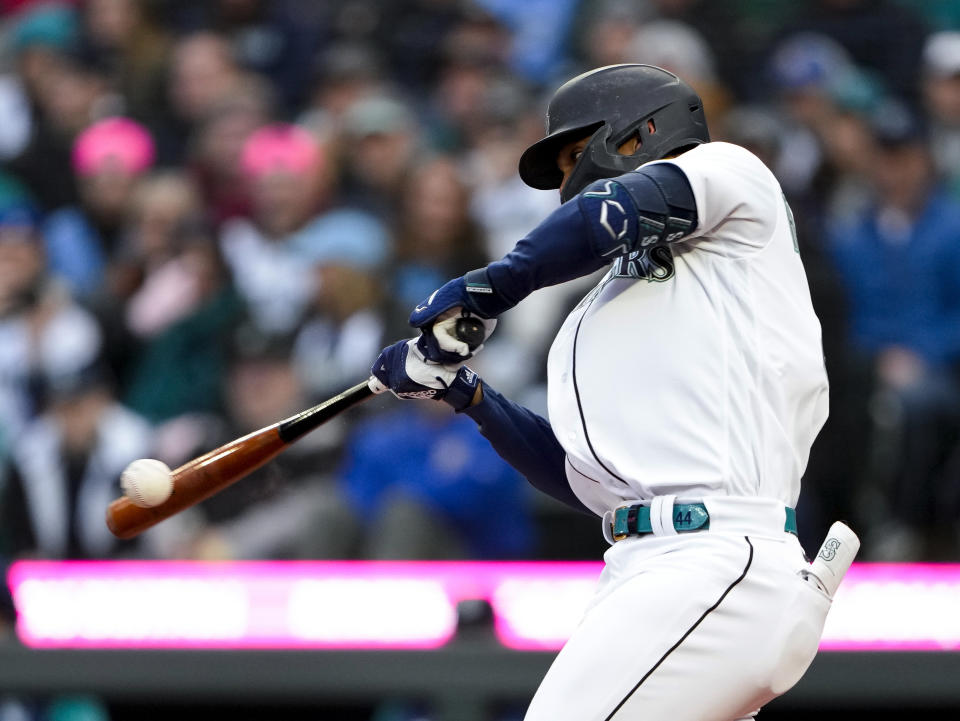 Seattle Mariners' Julio Rodriguez hits a single against the Cleveland Guardians during the first inning of a baseball game Saturday, April 1, 2023, in Seattle. (AP Photo/Lindsey Wasson)