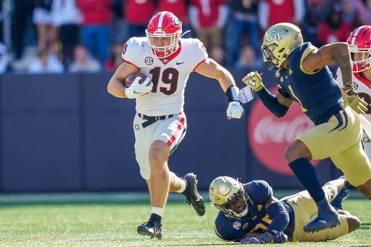 Nov 27, 2021; Atlanta, Georgia, USA; Georgia Bulldogs tight end Brock Bowers (19) breaks tackles running for a touchdown after a catch against the Georgia Tech Yellow Jackets during the first half at Bobby Dodd Stadium. Dale Zanine-USA TODAY Sports