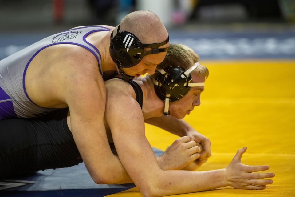 Gunner Henry of Brownsburg and Keith Miller of Northwood compete in the 190-pound first round match of 2023-24 IHSAA State Wrestling tournament at Ford Center in Evansville, Ind., Friday, Feb. 16, 2024.
